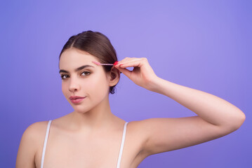 Beautiful woman with mascara eyebrows hold eyebrow brush. Eyebrows lamination. Brow beauty procedures. Combs eyebrows with a brus, eyebrow eye line.