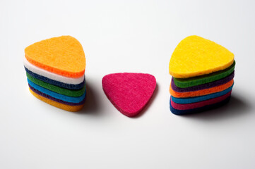 Felt picks in different colors for playing the ukulele or other string instruments.