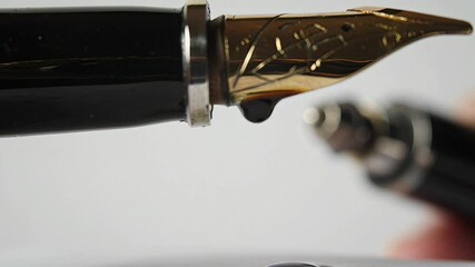 Fountain pen nib close up ink droplet - Powered by Adobe
