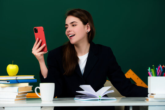 The new teacher is checking the homework. Attractive female student or new teacher. Learning language and education concept. Female young teacher. The student has been preparing for the exam.