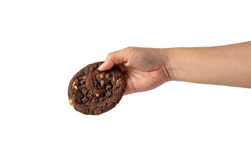 A large chocolate cookie topped with chocolate chips and hand, set against a transparent background.