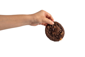 A large chocolate cookie topped with chocolate chips and hand, set against a transparent background.