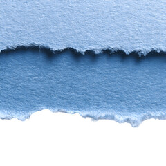 Close up of two torn pieces of light blue paper with a dark background underneath the bottom piece