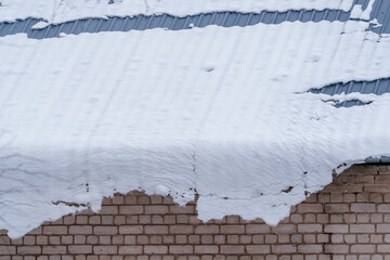 sliding snow overhang under the roof