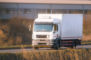 White truck with container on shipping route