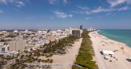 Fototapeta premium Beach in Miami with sunbed on a sandy beach with ocean waves. Miami Beach paradise with stunning views. South Beach Miami lifeguard post. Peaceful seaside retreat in Miami. Coastal relaxation.