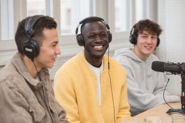 diverse group of young migrants passionately discussing their stories in modern podcast studio