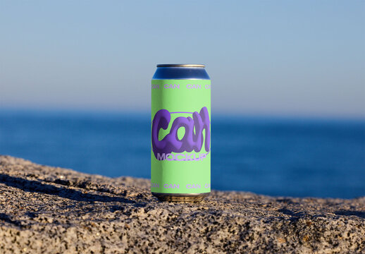 Blank Can Resting on Stone Near Ocean Shore. PSD mockup template ready for your logo design