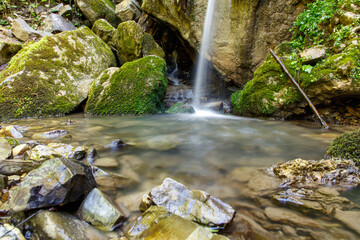 A small stream of water flows through a rocky area
