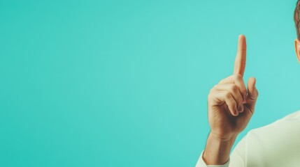 Man points to a bright blue background.