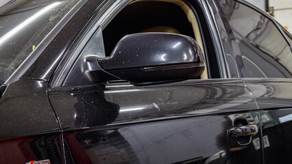 Black passenger car at the service station.