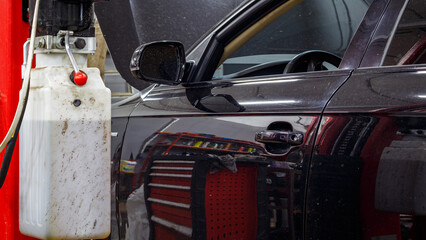 Black passenger car at the service station.