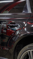 Black passenger car at the service station.