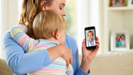 Mother and child having online telemedicine consultation with remote doctor or watching educational video by professional pediatrician. Family doctor online. Mom and kid receive medical care online