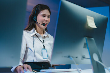 Asian female call center operator working night shift at office
