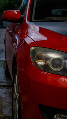 Red passenger car at the service station.
