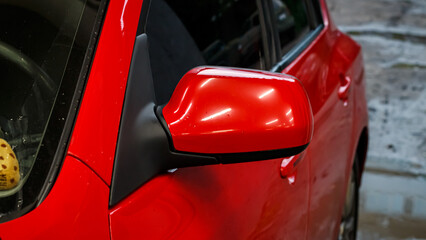 Red passenger car at the service station.