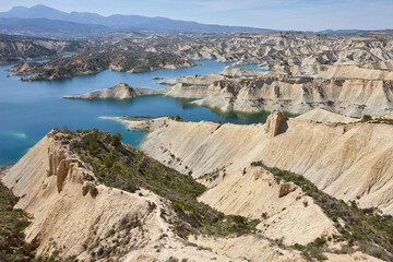 Badlands landscape and blue waters in Algeciras reservoir. Spain