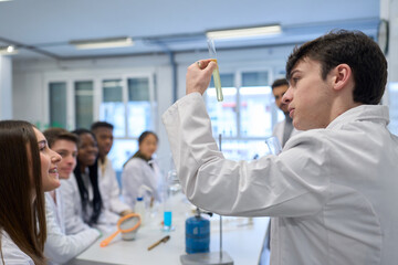 Chemistry student holding test tube observing chemical reaction in laboratory