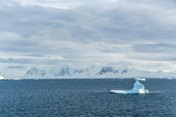 A tranquil Antarctic landscape, near Graham passage along Charlotte Bay, highlighting stark...