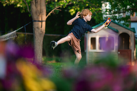 Young boy catches baseball during outdoor backyard play