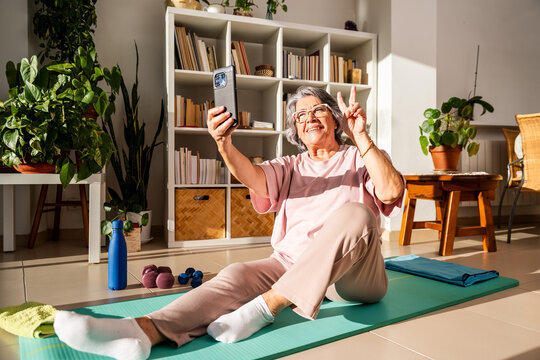 Older Woman Captures Joyful Moment After Exercising at Home With Phone