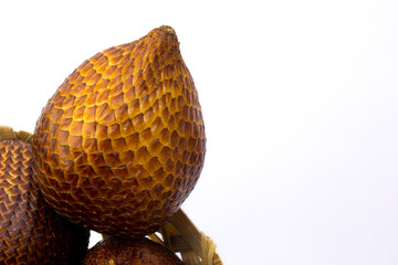 Close-up of snake fruit against white background. Salak or Snake fruit is a source of phenolic compounds and antioxidative properties associated with health benefits. 