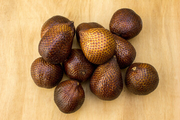 Close-up of snake fruit against white background. Salak, commonly known as snake fruit, is a unique tropical fruit native to Indonesia but is now widely cultivated across Southeast Asia. 