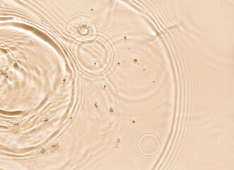 water texture ripples wave clean transparent water abstract background in beige color