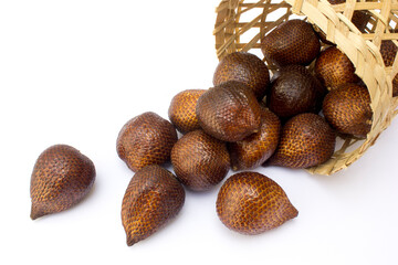 Some salak fruit in a woven bamboo basket, isolated in white. Salak, commonly known as snake fruit, is a unique tropical fruit native to Indonesia but is now widely cultivated across Southeast Asia. 