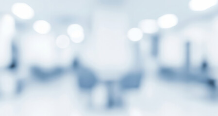 Blurred interior space with chairs and light tones creating an abstract background.