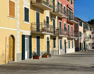 Old street in Italian countryside near sea. Traditional building. Sun day. Entrance, window to house. Nature and sky. 