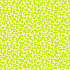 Seamless vector animal print pattern with bold green spots on a yellow background. Trendy and modern design for textiles, fashion, wrapping paper, and digital projects