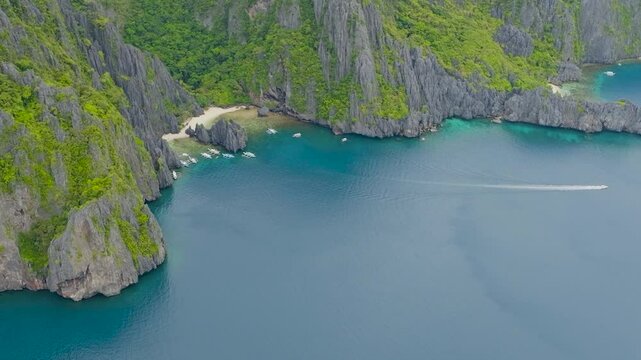 Boats in Secret Lagoon and Jiji's Beach. Miniloc Island with and blue sea in El Nido, Palawan. Philippines.