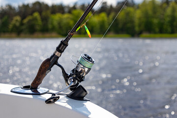Swivel bite on a fish boat, reels against the background of a river, sunny day. 