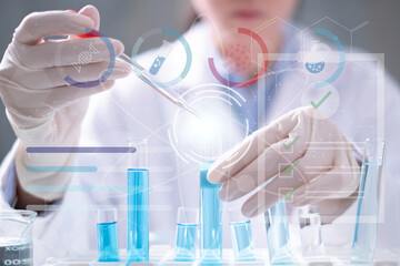 Close-up hand scientist dropping blue fluid into test tube laboratory research chemistry medicine...