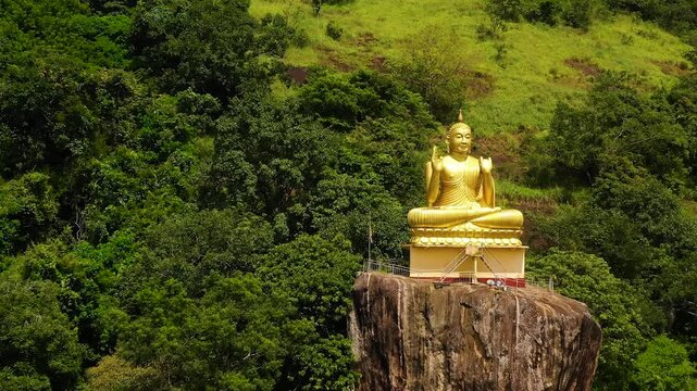 Buddha statue at a hill slope near Aluvihare Rock Temple. Aluvihara Rock Temple, Matale Sri Lanka.