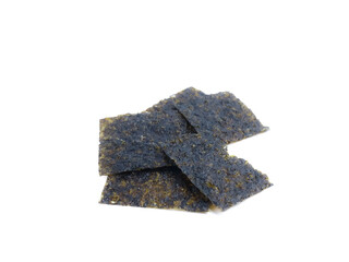 Stacked roasted seaweed snack sheets on a white background, close-up food detail.