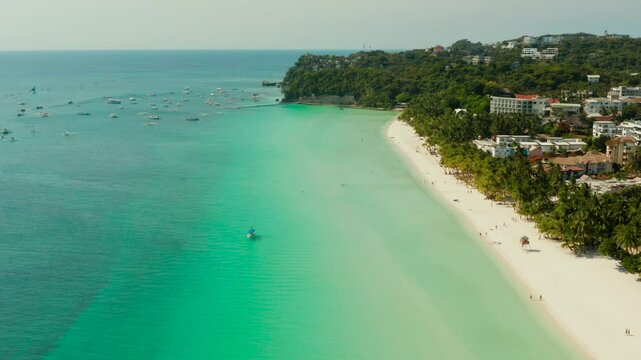 Tropical white sand beach, hotels near the blue lagoon and corall reef. aerial view, Boracay, Philippines. Seascape with beach on tropical island. Summer and travel vacation concept.