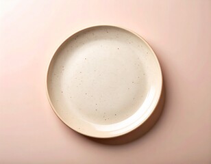 Cream Speckled Ceramic Plate Centered on Soft Pink Surface