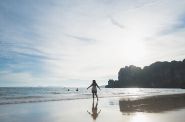 happy woman stand on the beach at krabi province, Thailand. soft focus