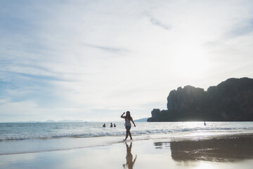 happy woman stand on the beach at krabi province, Thailand. soft focus