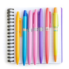 A top view of a spiral notebook with lined paper and colorful pens arranged neatly on top of it flat lay
