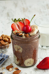 chocolate overnight oats with fresh berries,  banana and  nuts