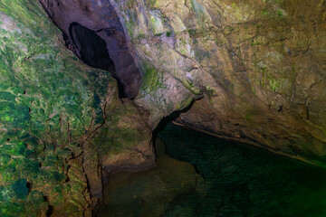 transparent stream and rocks in the cave