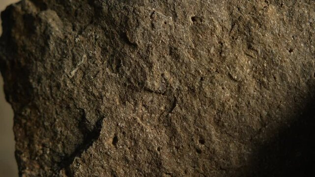 Close-up shot of rough stone wall texture in natural light
