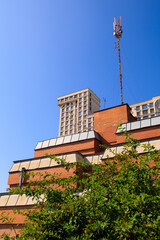 Cityscape on a sunny day. Modern building against the blue sky.