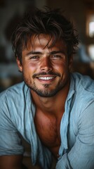 Fototapeta premium Friendly close up portrait of a handsome smiling man with beard and cheerful eyes on dark background