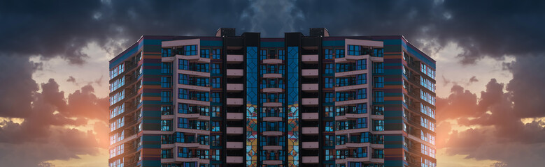 Evening view of the city. Sunset orange sky and beautiful cityscape, buildings and city streets,...