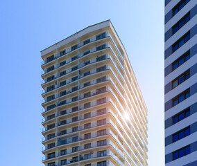 City view on a sunny day. Modern houses against the blue sky.